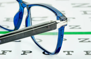 Glasses laying on an eye exam chart